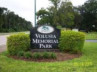 vollusia memorial park logo